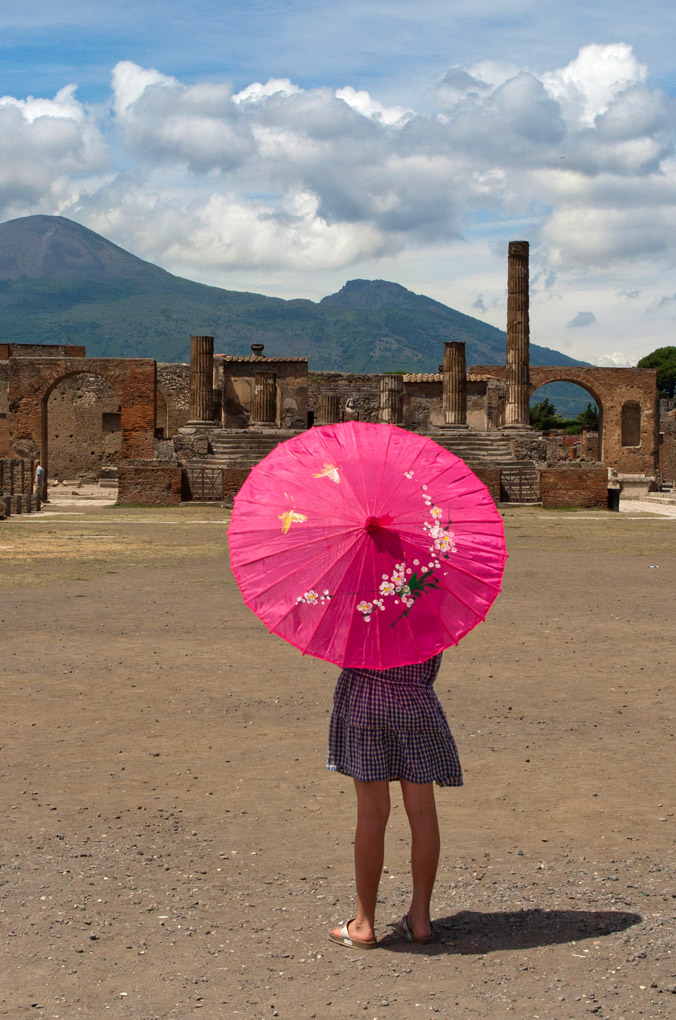 street photography, pink umbrella, ancient, child in pink