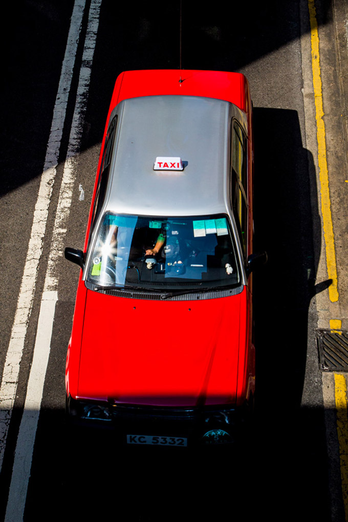 red taxi, red cab, business district, city, urban landscape, street photography, taxi, cabs, red taxis, transportations, contrast, shadows in the city, Mercedes Noriega, Mercedes Noriega Photography